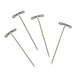 Close-up of four steel T-pins showing the looped T-shaped heads and pointed tips