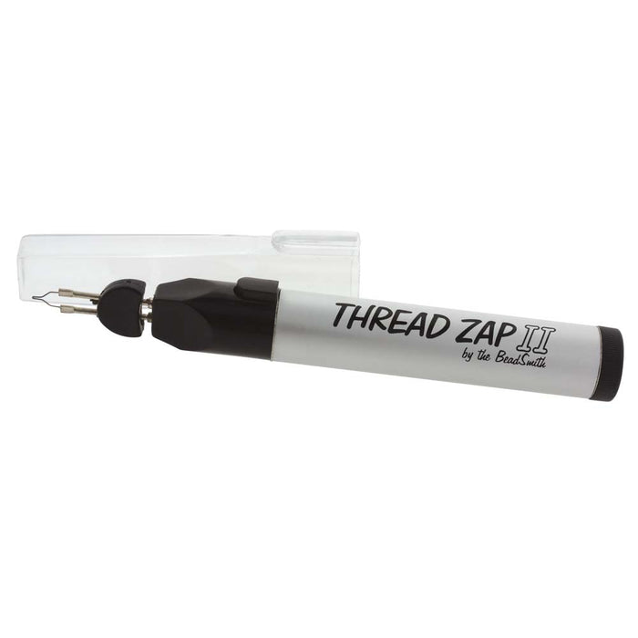 BeadSmith Thread Zap II thread burner with clear cap resting beside the heating tip, side view
