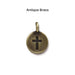 Antiqued brass cross coin charm, front
