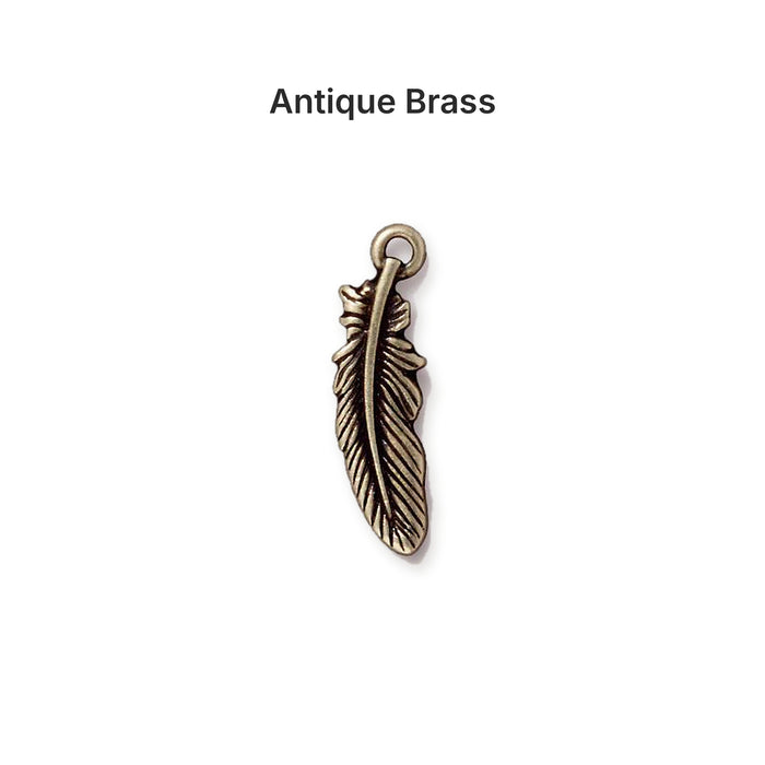 Antiqued brass feather charm, front