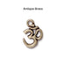 Antiqued brass open Om charm, front