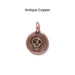 Antiqued copper skull coin charm, front
