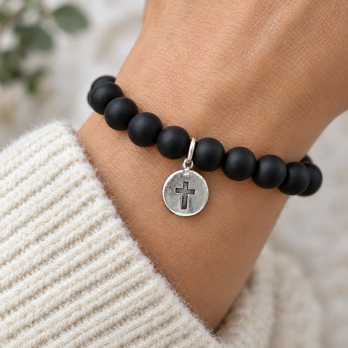 Antiqued silver cross coin charm on a black onyx bead bracelet, design idea