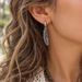 Antiqued silver feather charm on a hoop earring, design idea