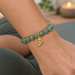 Gold open Om charm on an aventurine mala bracelet, design idea