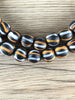 Hidden Gems: Orange & White Striped Black Java Glass Beads