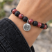 Antiqued silver skull coin charm on a lava stone and jasper bead bracelet, design idea